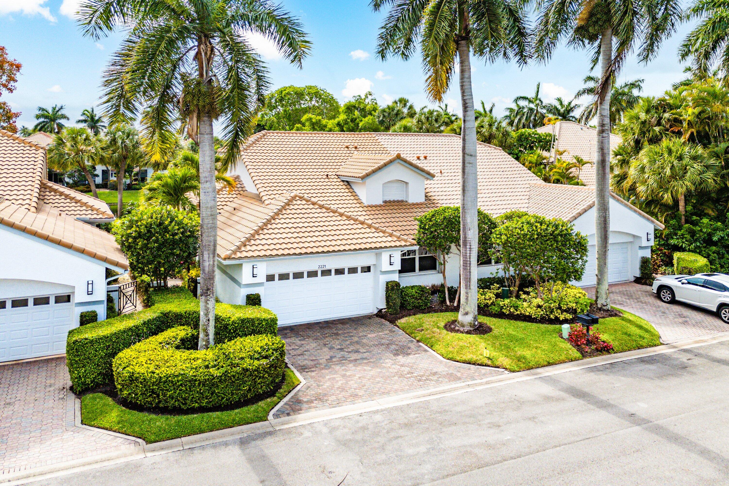 2221 Northwest 62nd Drive Boca Raton, FL 33496 - Photo 30 of 62 a front view of a house with garden