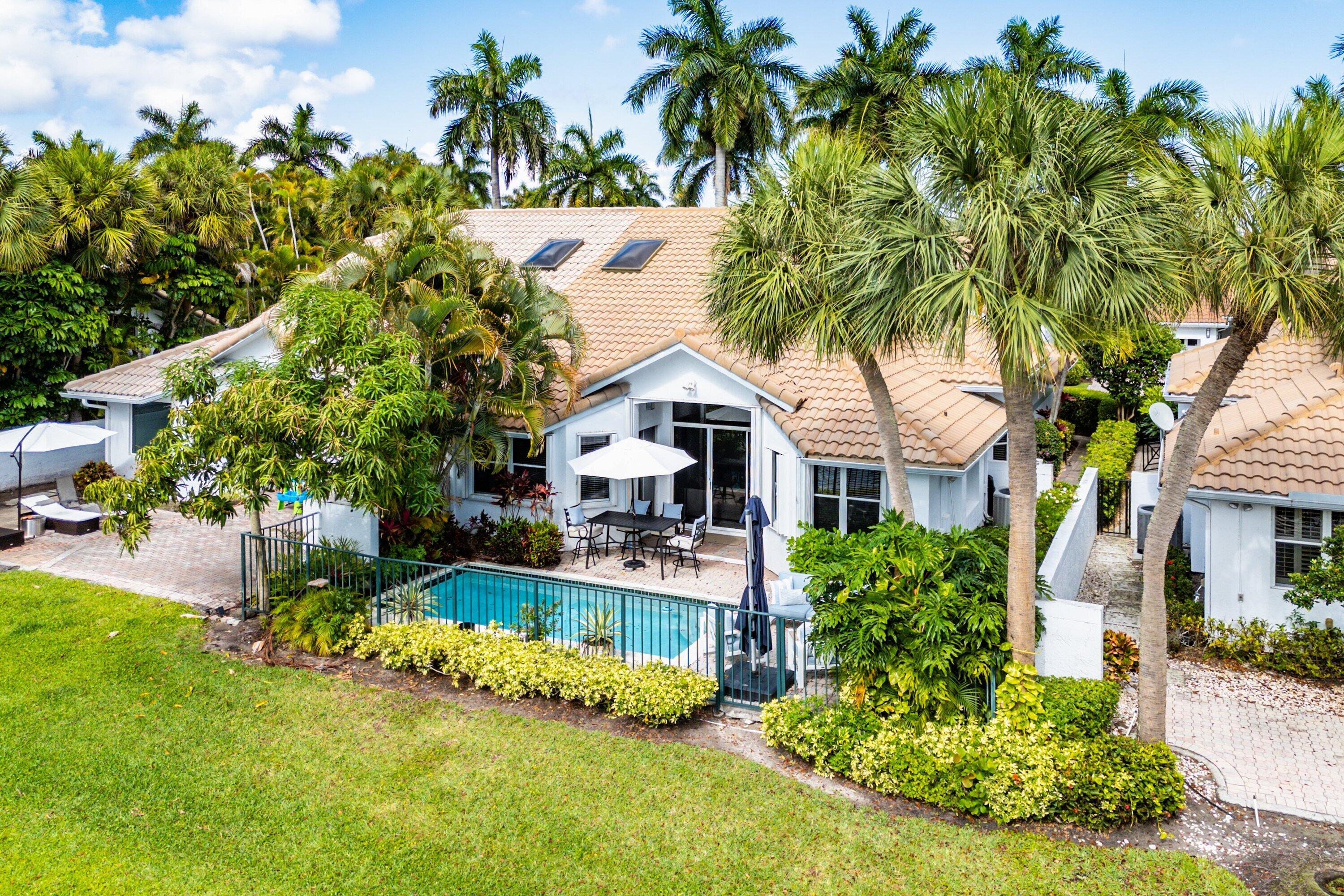 2221 Northwest 62nd Drive Boca Raton, FL 33496 - Photo 34 of 62 a front view of a house with a garden