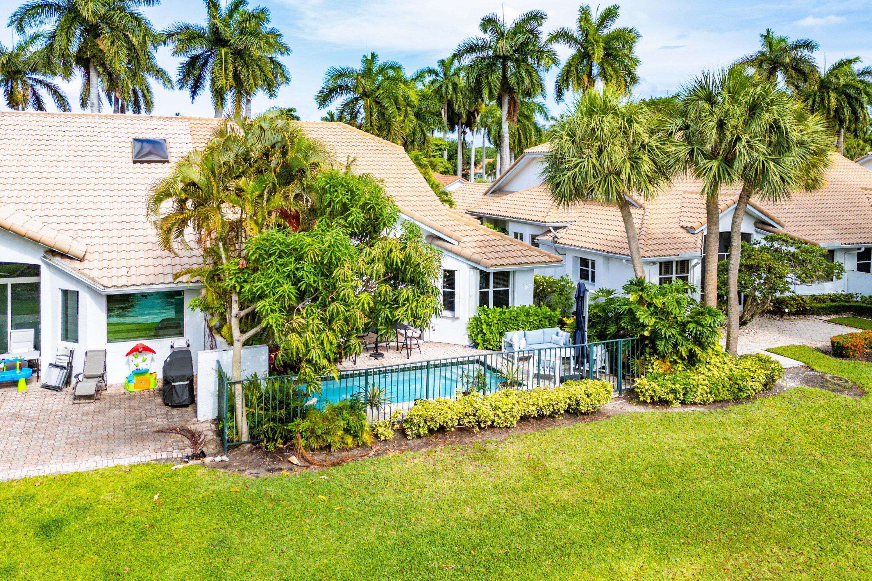 2221 Northwest 62nd Drive Boca Raton, FL 33496 - Photo 35 of 62 a front view of a house with garden