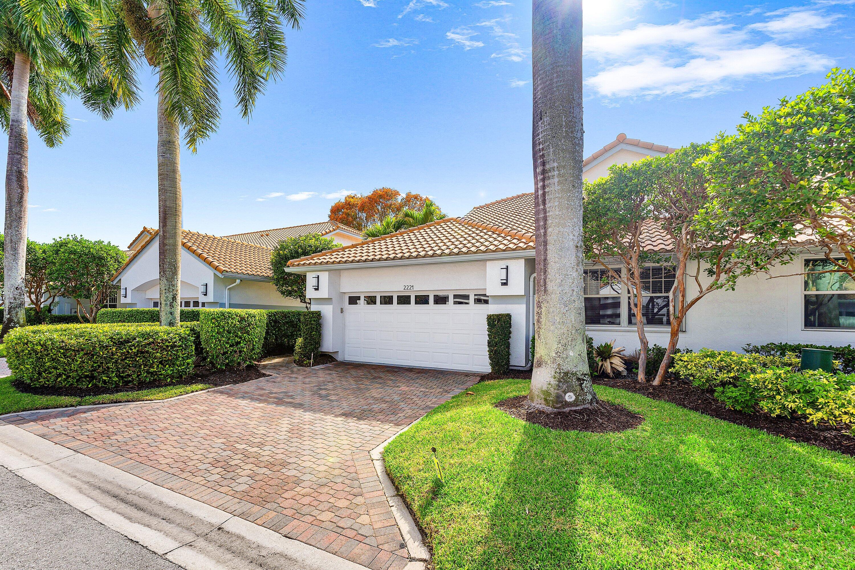 2221 Northwest 62nd Drive Boca Raton, FL 33496 - Photo 7 of 62 a front view of a house with garden