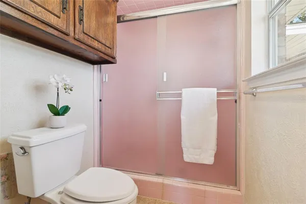 a white toilet sitting next to a bathroom sink
