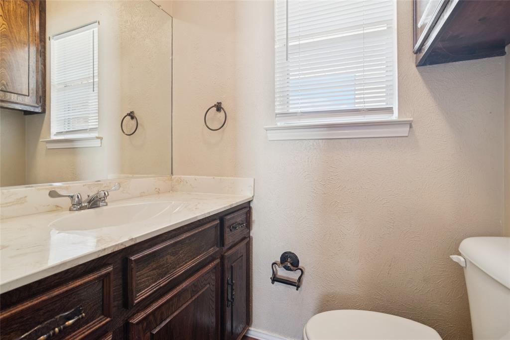 941 Maple Street Howe, TX 75459 - Photo 26 of 37 a bathroom with a granite countertop sink and a mirror