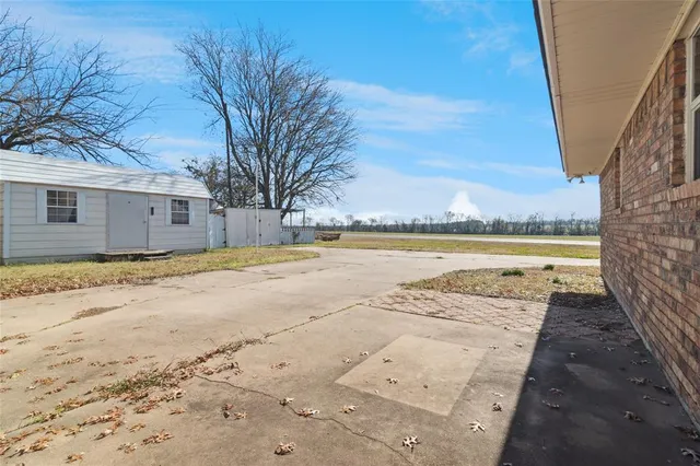 a view of a backyard with wooden fence