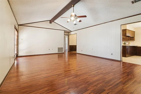 a view of a room with wooden floor