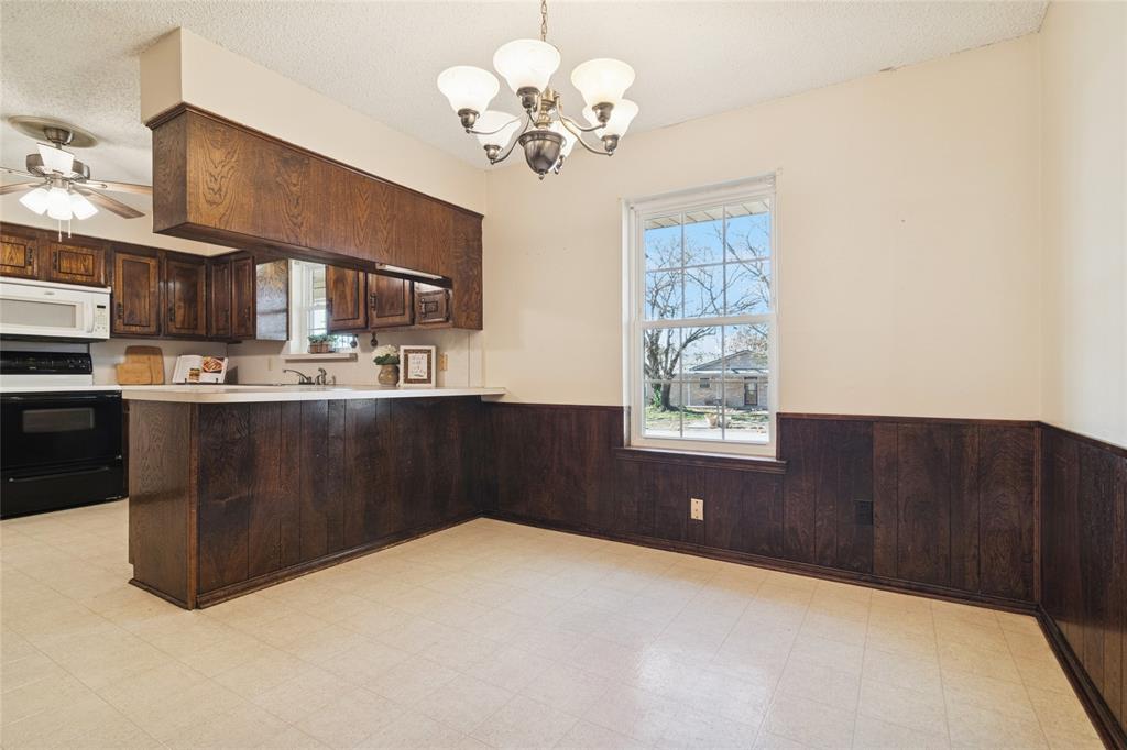 941 Maple Street Howe, TX 75459 - Photo 9 of 37 a kitchen with a cabinets and chandelier