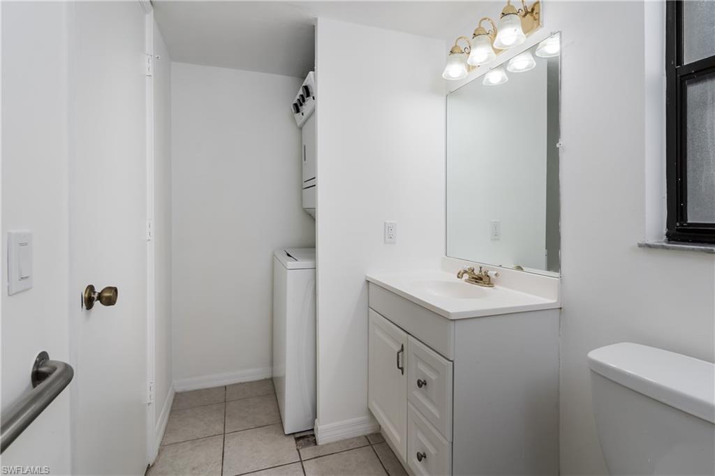 5501 Rattlesnake Hammock Road, Unit 601 Naples, FL 34113 - Photo 15 of 21 a bathroom with a sink a toilet and mirror