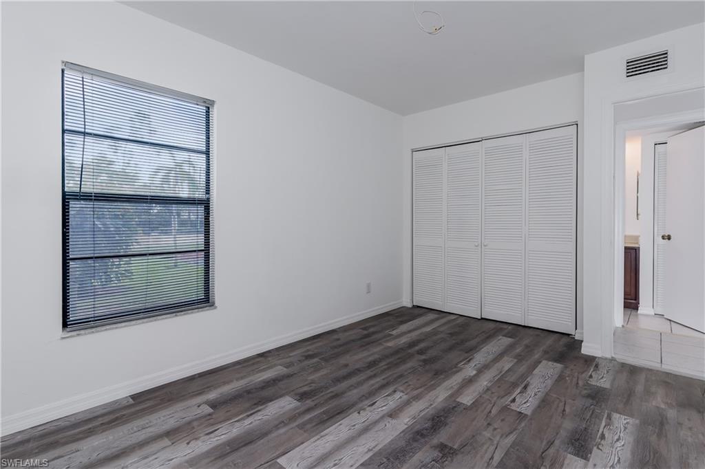 5501 Rattlesnake Hammock Road, Unit 601 Naples, FL 34113 - Photo 17 of 21 a view of an empty room with wooden floor and a window