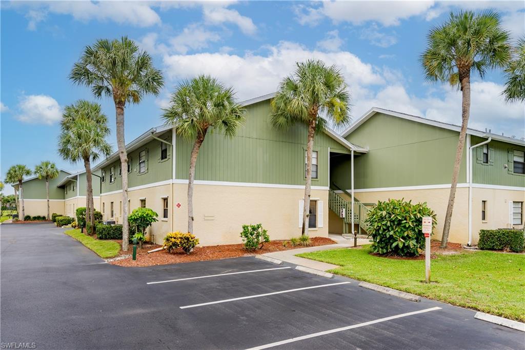 5501 Rattlesnake Hammock Road, Unit 601 Naples, FL 34113 - Photo 21 of 21 a front view of a house with garden