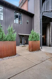 a view of a patio with chairs and potted plants