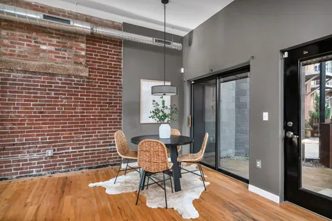 a view of a livingroom with chair and front door