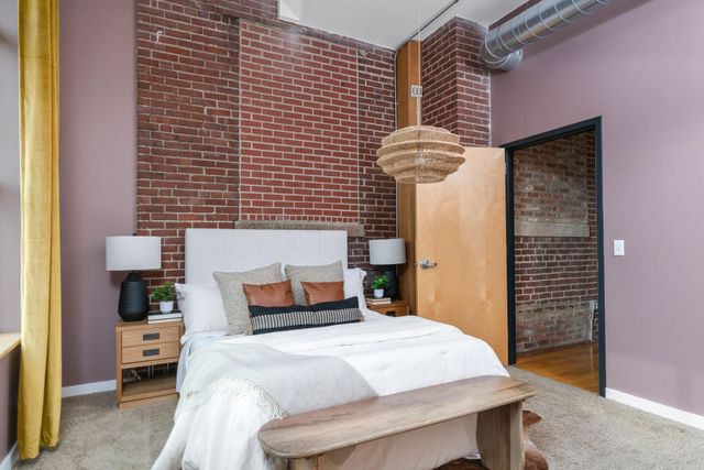 a bedroom with a large bed and a large window