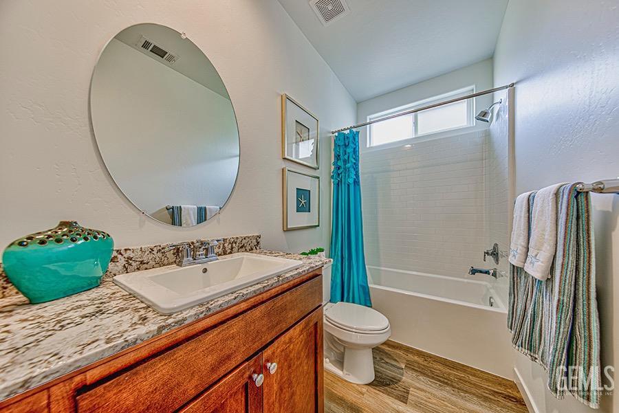 Undisclosed Address Bakersfield, CA 93311 - Photo 7 of 9 a bathroom with a sink a toilet and a bathtub