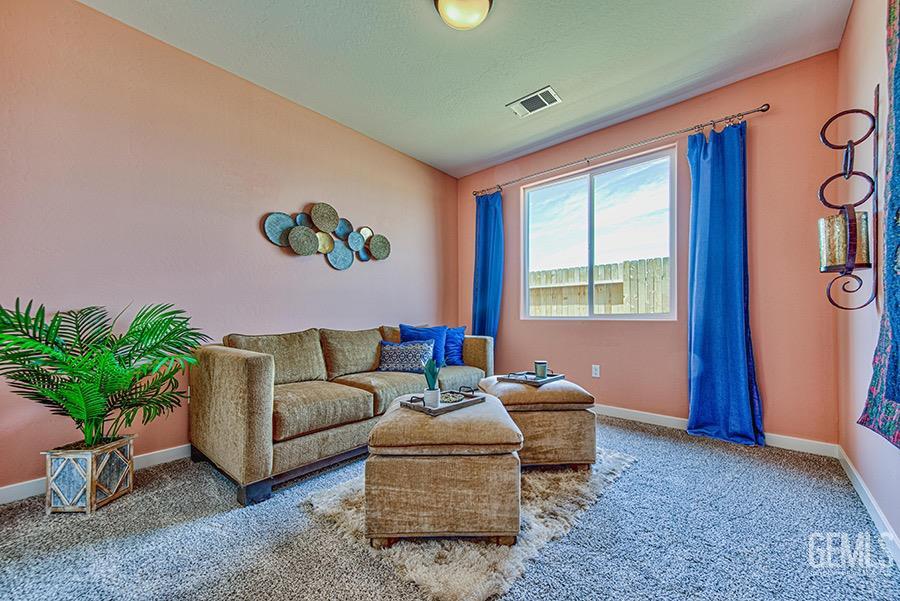 Undisclosed Address Bakersfield, CA 93311 - Photo 9 of 9 a living room with furniture and a potted plant