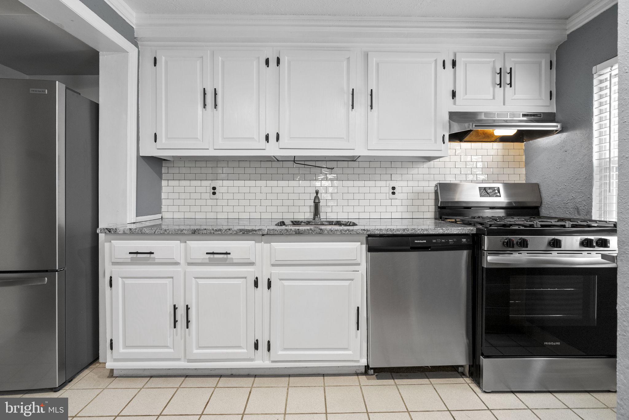 215 Allison Road Oreland, PA 19075 - Photo 12 of 39 a kitchen with granite countertop white cabinets stainless steel appliances and a sink