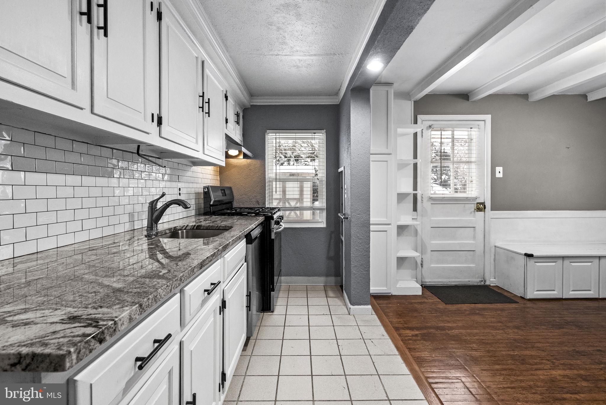 215 Allison Road Oreland, PA 19075 - Photo 13 of 39 a kitchen with stainless steel appliances granite countertop a sink and cabinets
