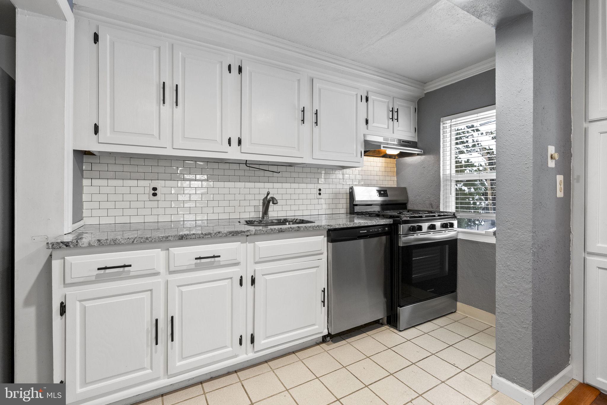 215 Allison Road Oreland, PA 19075 - Photo 14 of 39 a kitchen with granite countertop white cabinets and stainless steel appliances