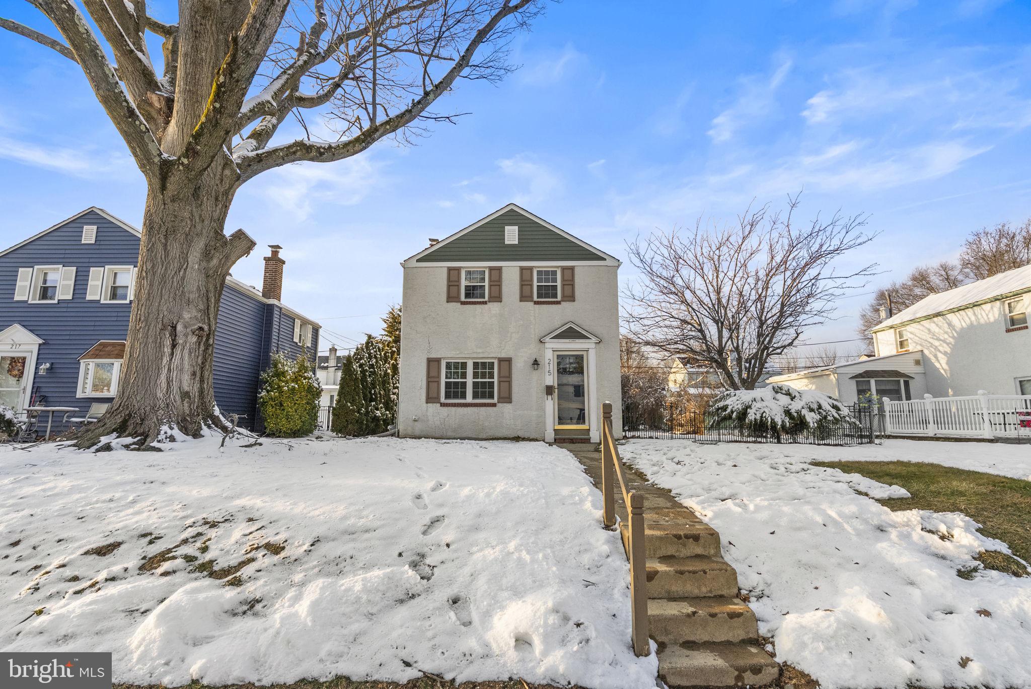 215 Allison Road Oreland, PA 19075 - Photo 2 of 39 a front view of a house with a yard covered in snow