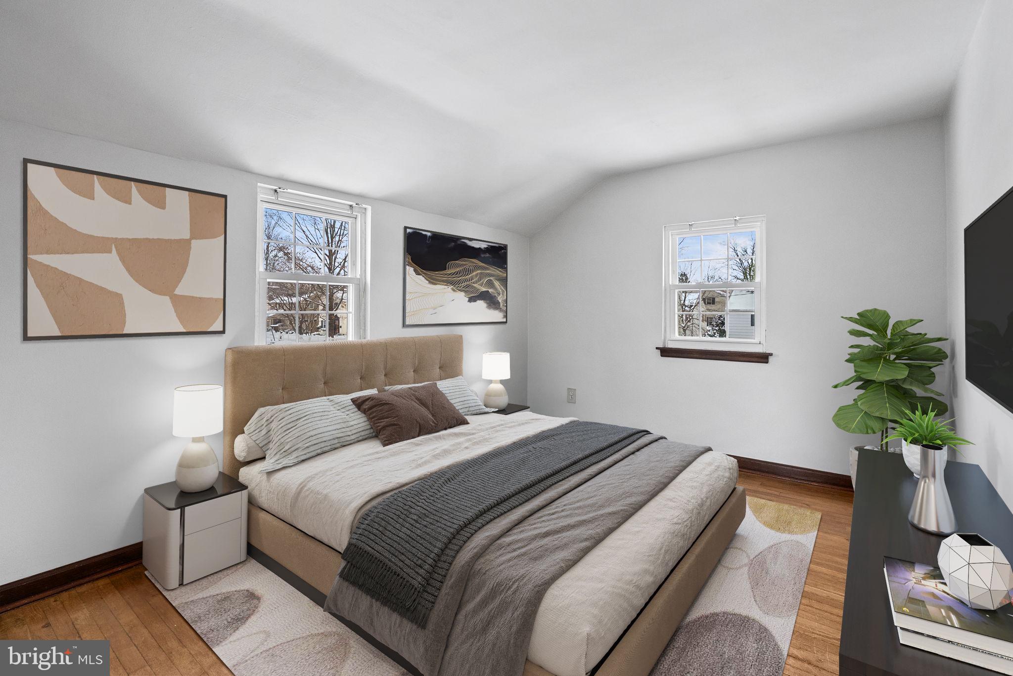 215 Allison Road Oreland, PA 19075 - Photo 21 of 39 a bedroom with a bed lamp and paintings on the wall