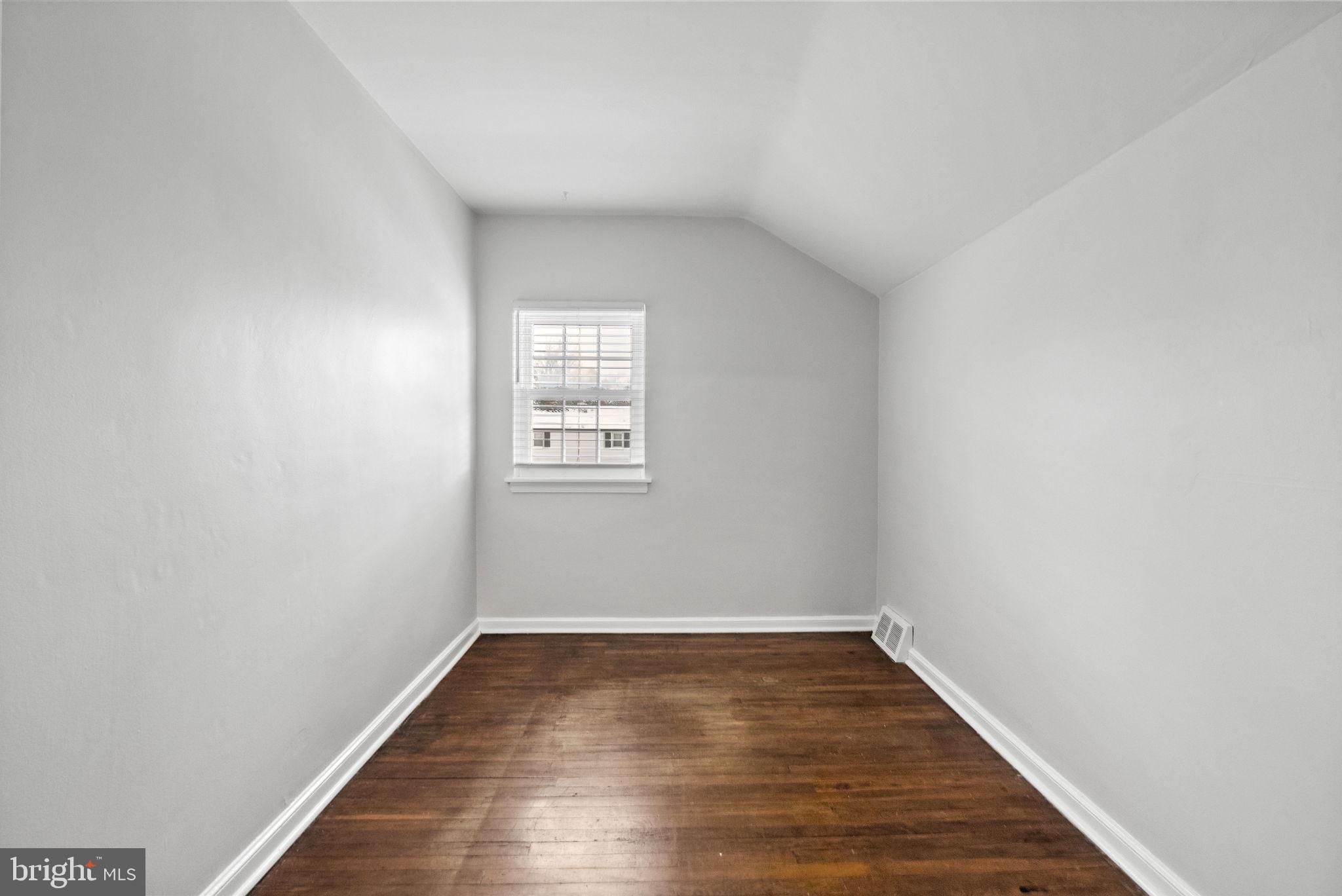 215 Allison Road Oreland, PA 19075 - Photo 28 of 39 an empty room with wooden floor and windows