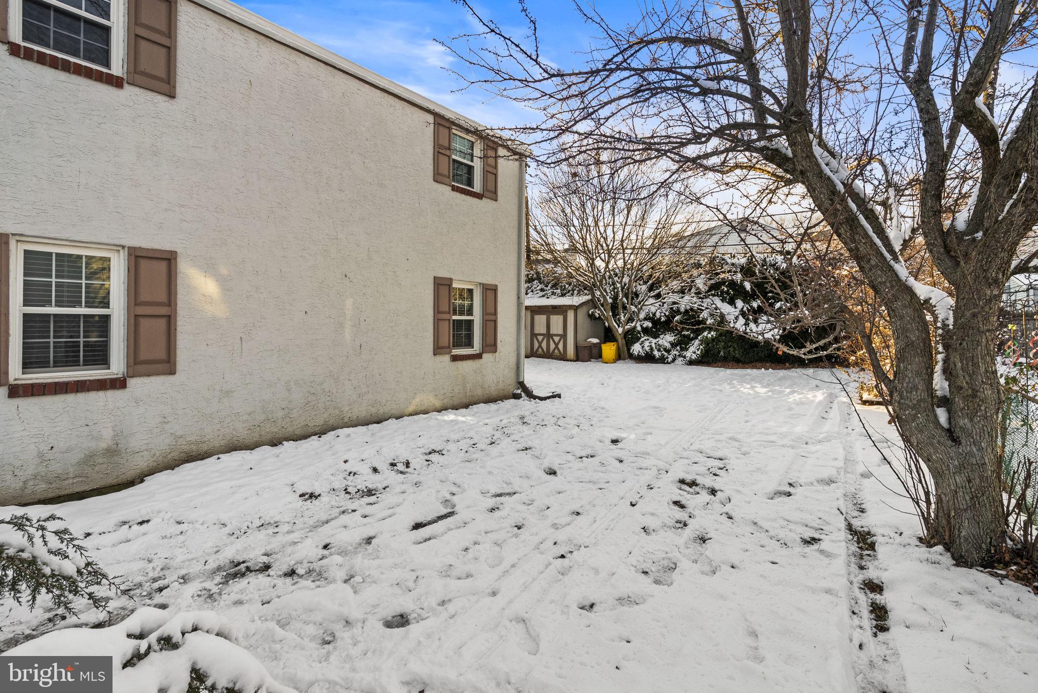 215 Allison Road Oreland, PA 19075 - Photo 30 of 39 a view of a backyard with a large tree