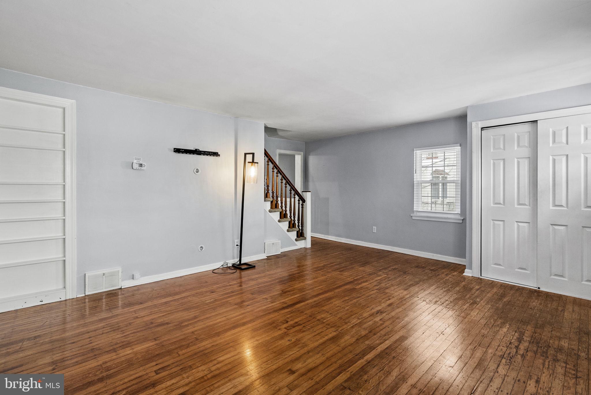 215 Allison Road Oreland, PA 19075 - Photo 6 of 39 a view of an empty room with wooden floor and a window