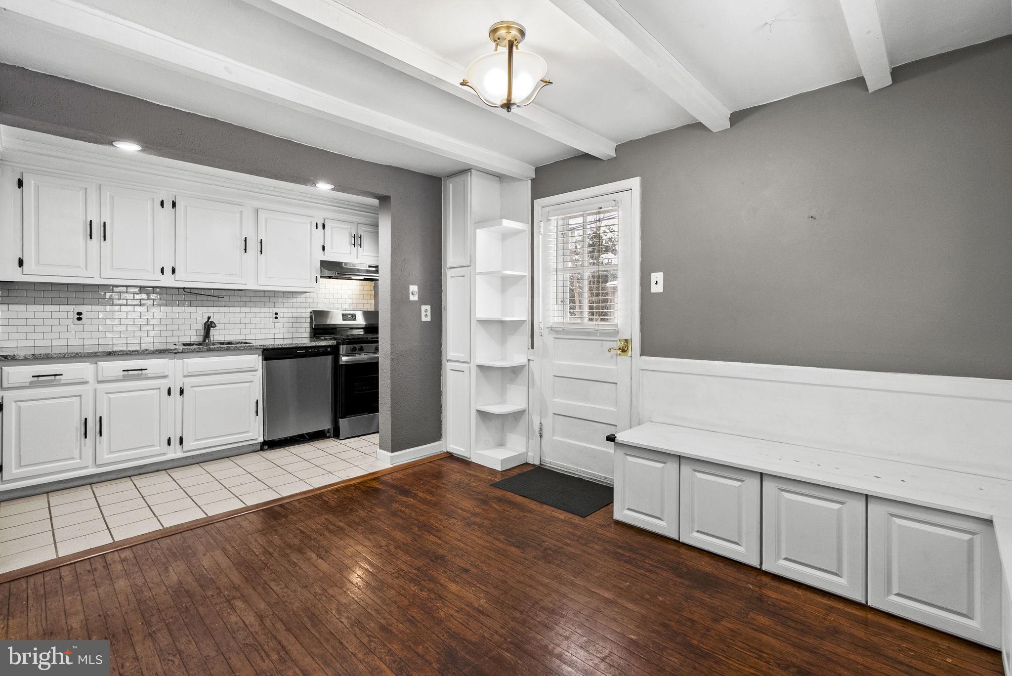 215 Allison Road Oreland, PA 19075 - Photo 9 of 39 a kitchen with stainless steel appliances granite countertop a refrigerator a sink dishwasher a stove and white cabinets with wooden floor
