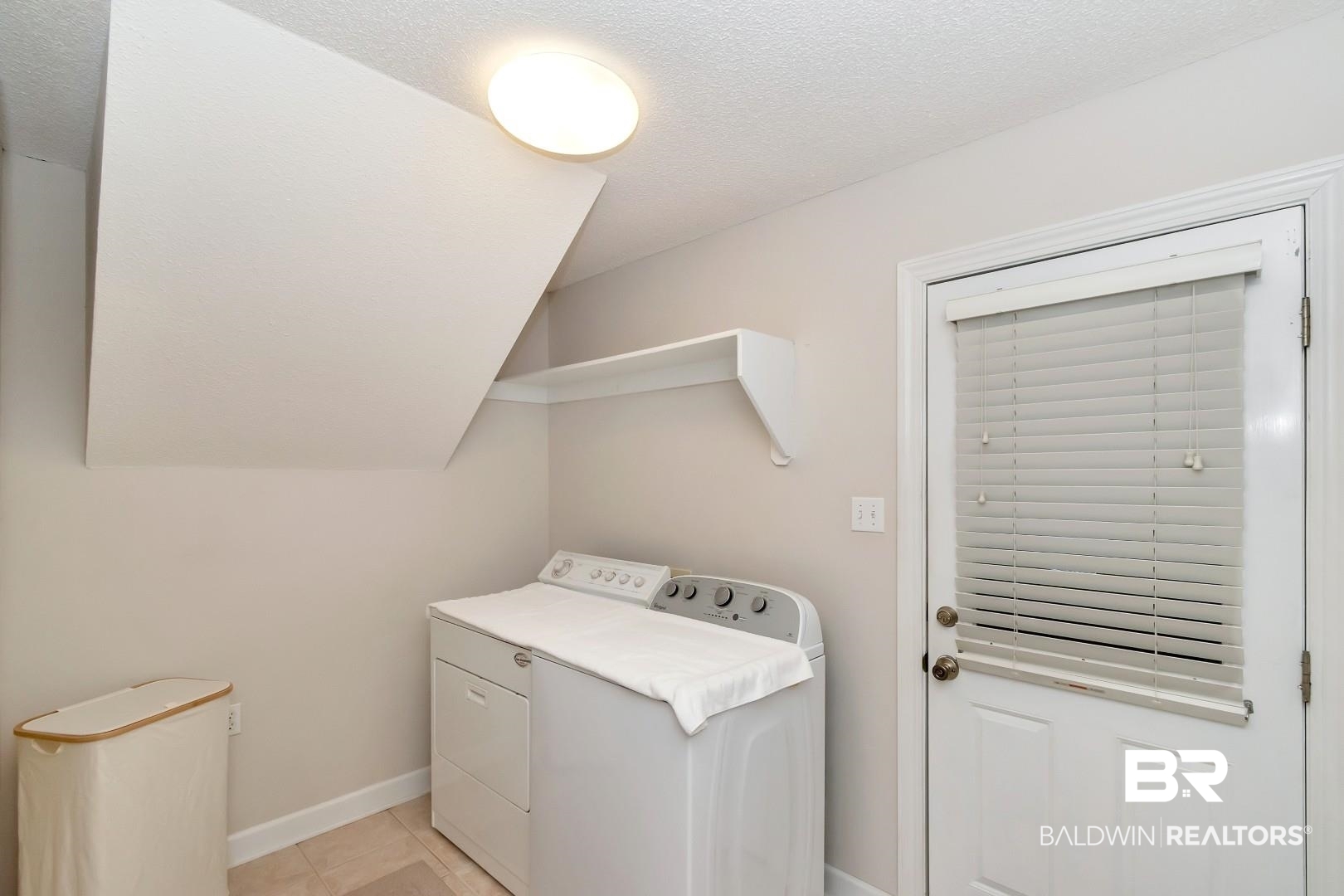 6090 Celeste Road Saraland, AL 36571 - Photo 22 of 38 Clothes washing area with a textured ceiling, baseboards, laundry area, washer and dryer, and light tile patterned floors