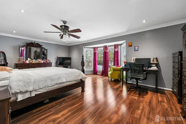 a bedroom with a bed furniture and a chandelier
