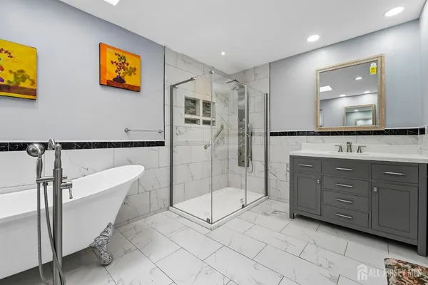 a spacious bathroom with a shower sink and mirror