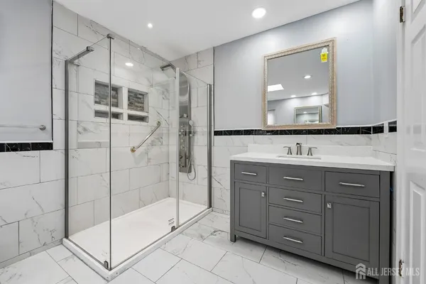 a bathroom with a shower sink and mirror