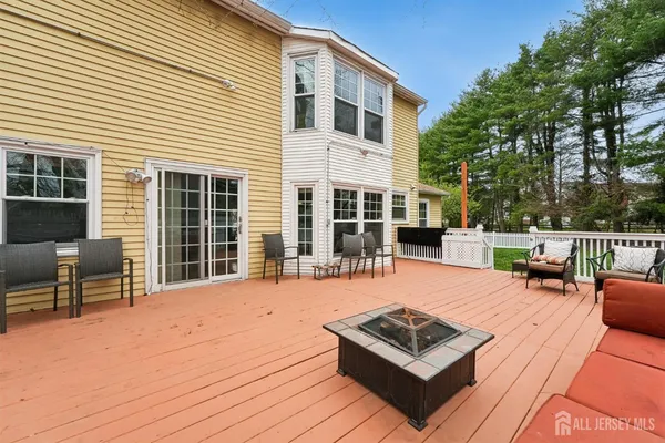 a view of a roof deck with chair and tables