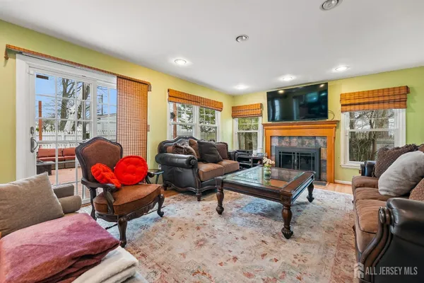 a living room with furniture a flat screen tv and a fireplace