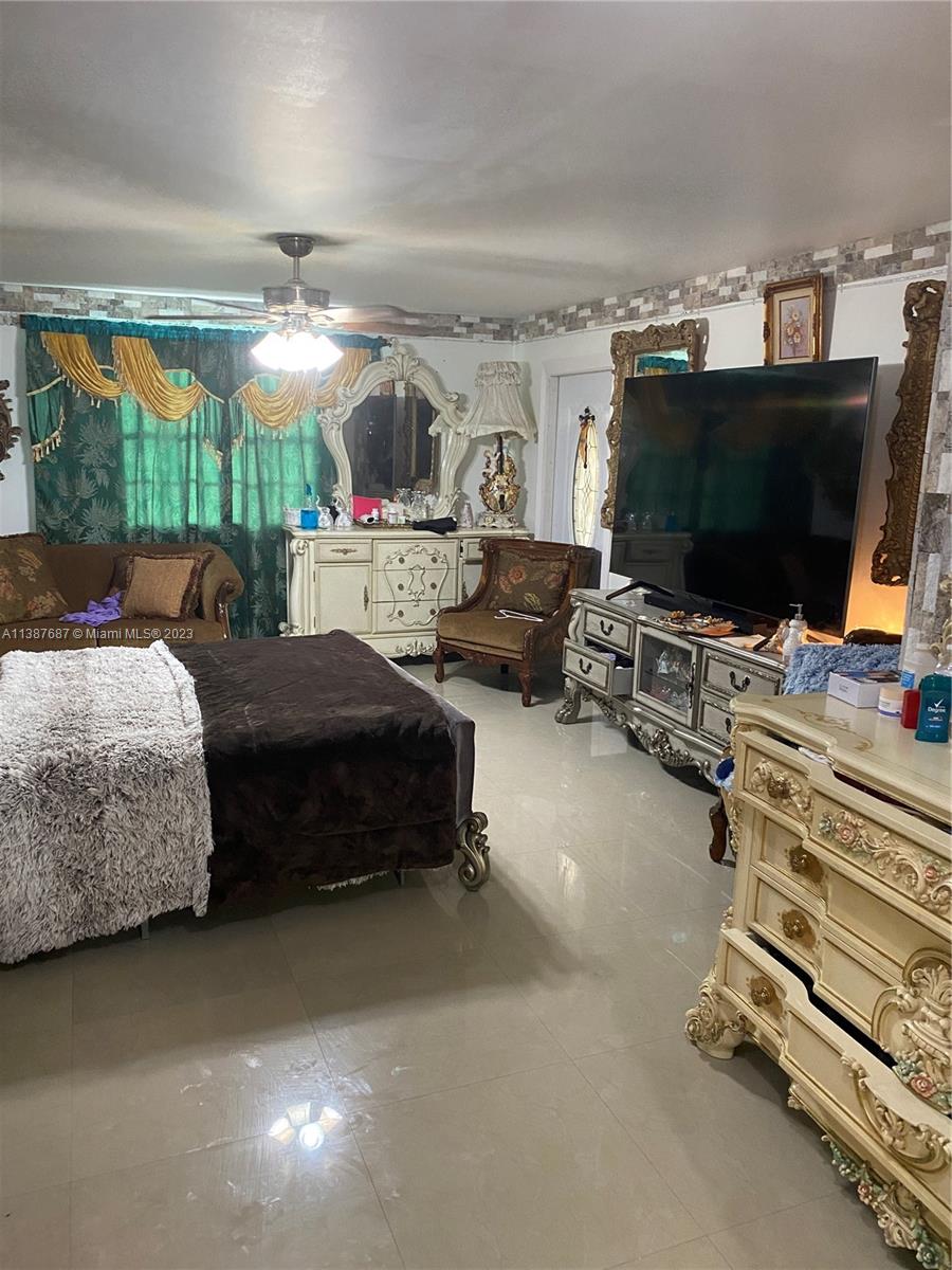 29220 Kansas Road Homestead, FL 33033 - Photo 8 of 16 a bedroom with furniture and a flat screen tv