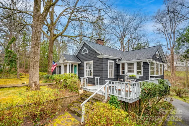 a front view of a house with a yard table and chairs