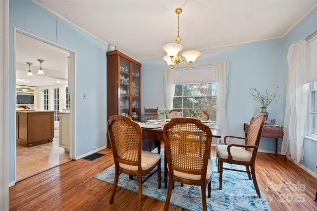 a view of a dining room with furniture wooden floor and chandelier