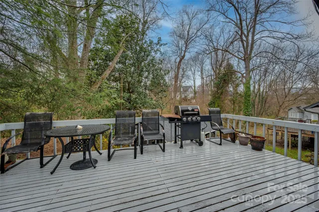 a view of a dinning table and chairs on deck with wooden floor