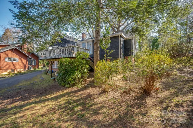 a view of a house with a tree and plants