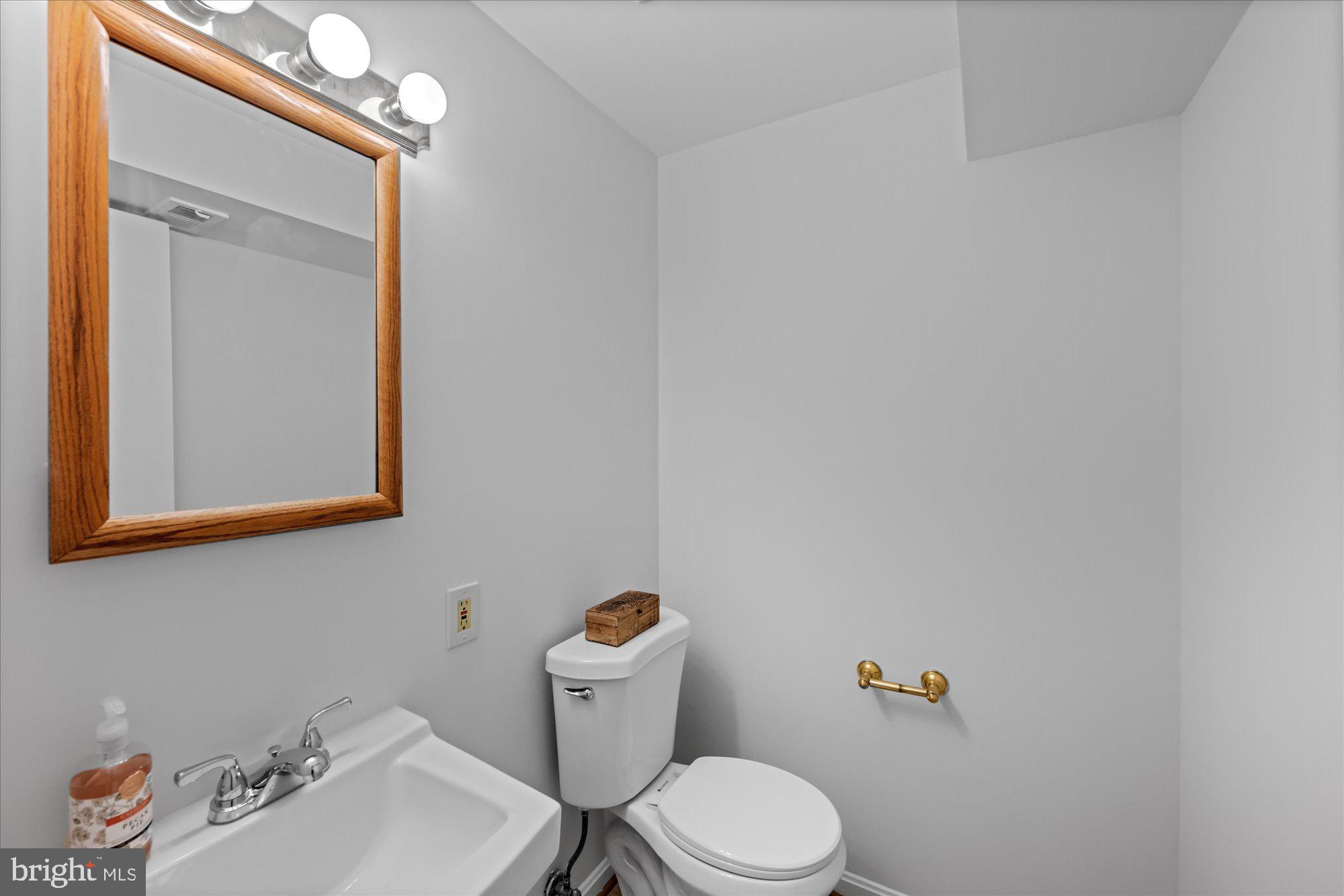 8311 Aqueduct Road Potomac, MD 20854 - Photo 12 of 27 a white toilet sitting next to a bathroom sink