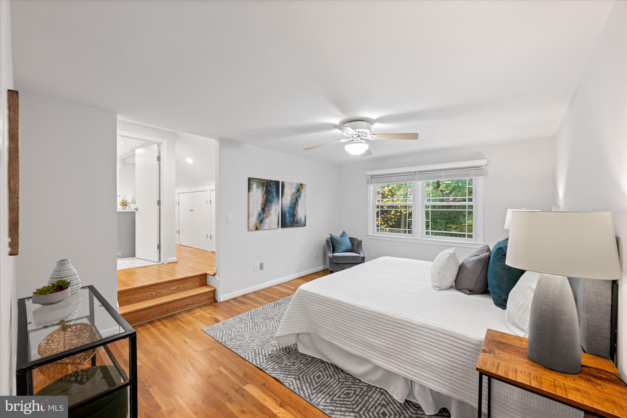 8311 Aqueduct Road Potomac, MD 20854 - Photo 13 of 27 a bedroom with a bed and wooden floor