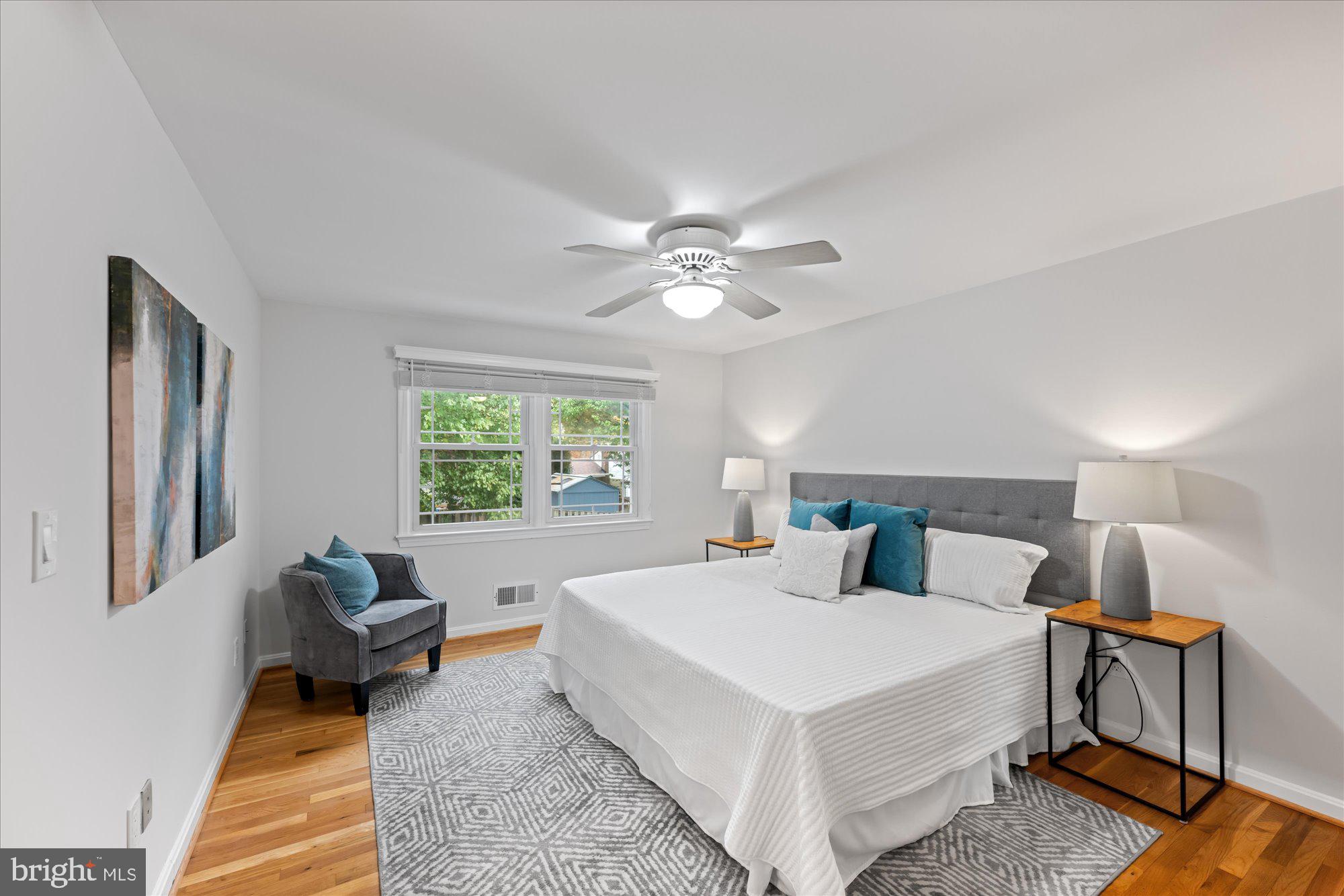 8311 Aqueduct Road Potomac, MD 20854 - Photo 14 of 27 a bedroom with a bed and wooden floor