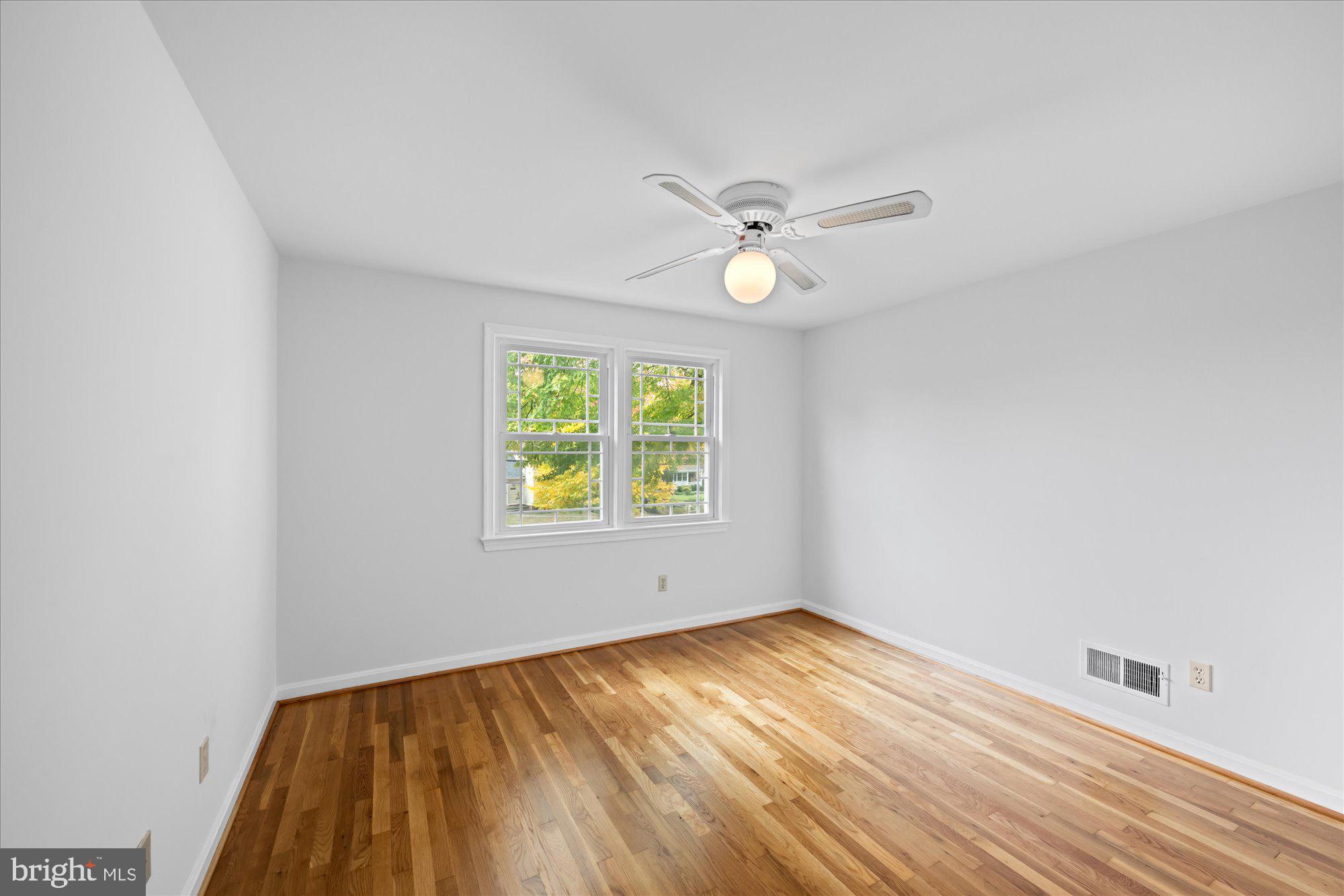 8311 Aqueduct Road Potomac, MD 20854 - Photo 17 of 27 an empty room with a window and ceiling fan