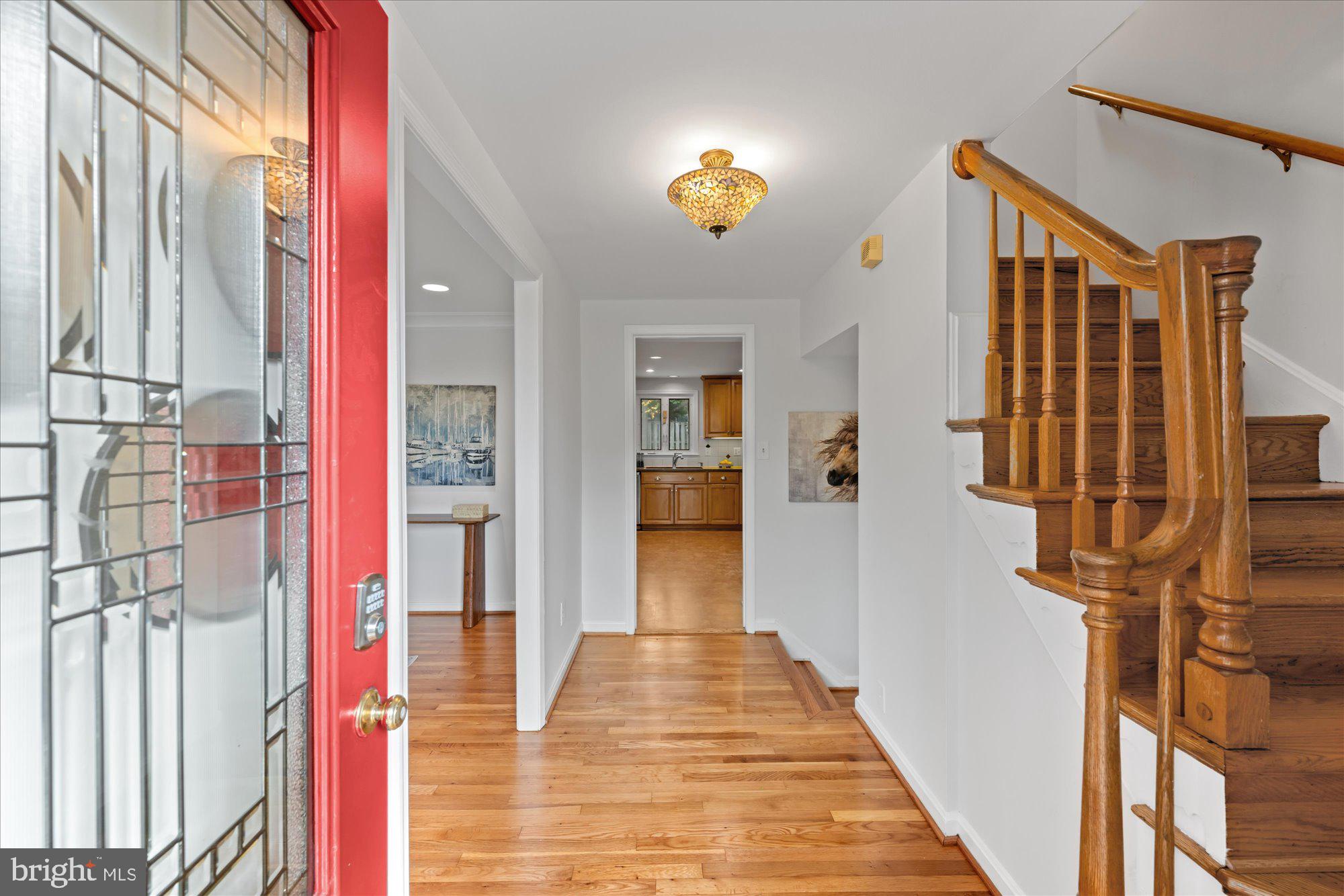 8311 Aqueduct Road Potomac, MD 20854 - Photo 2 of 27 a view of a hallway with wooden floor and staircase