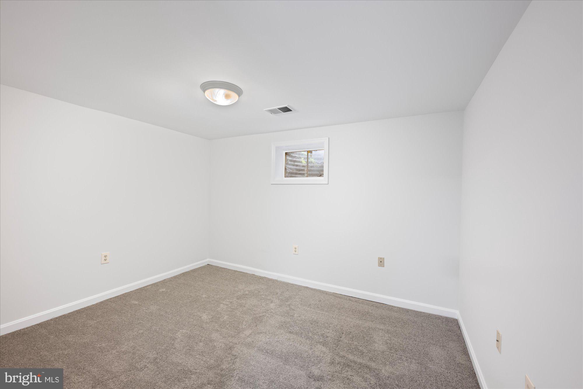 8311 Aqueduct Road Potomac, MD 20854 - Photo 22 of 27 an empty room with a workbench