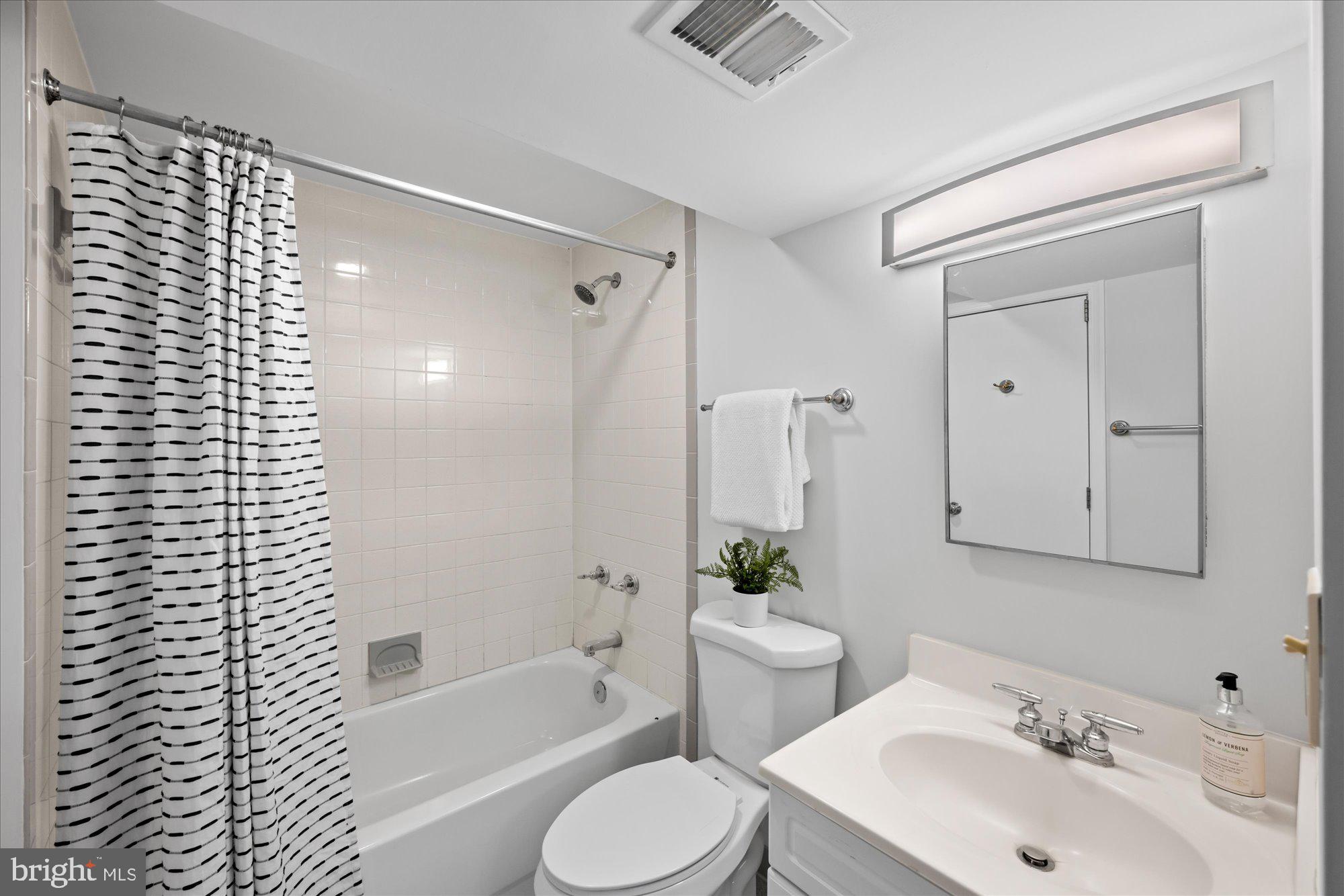 8311 Aqueduct Road Potomac, MD 20854 - Photo 23 of 27 a bathroom with a sink toilet and shower