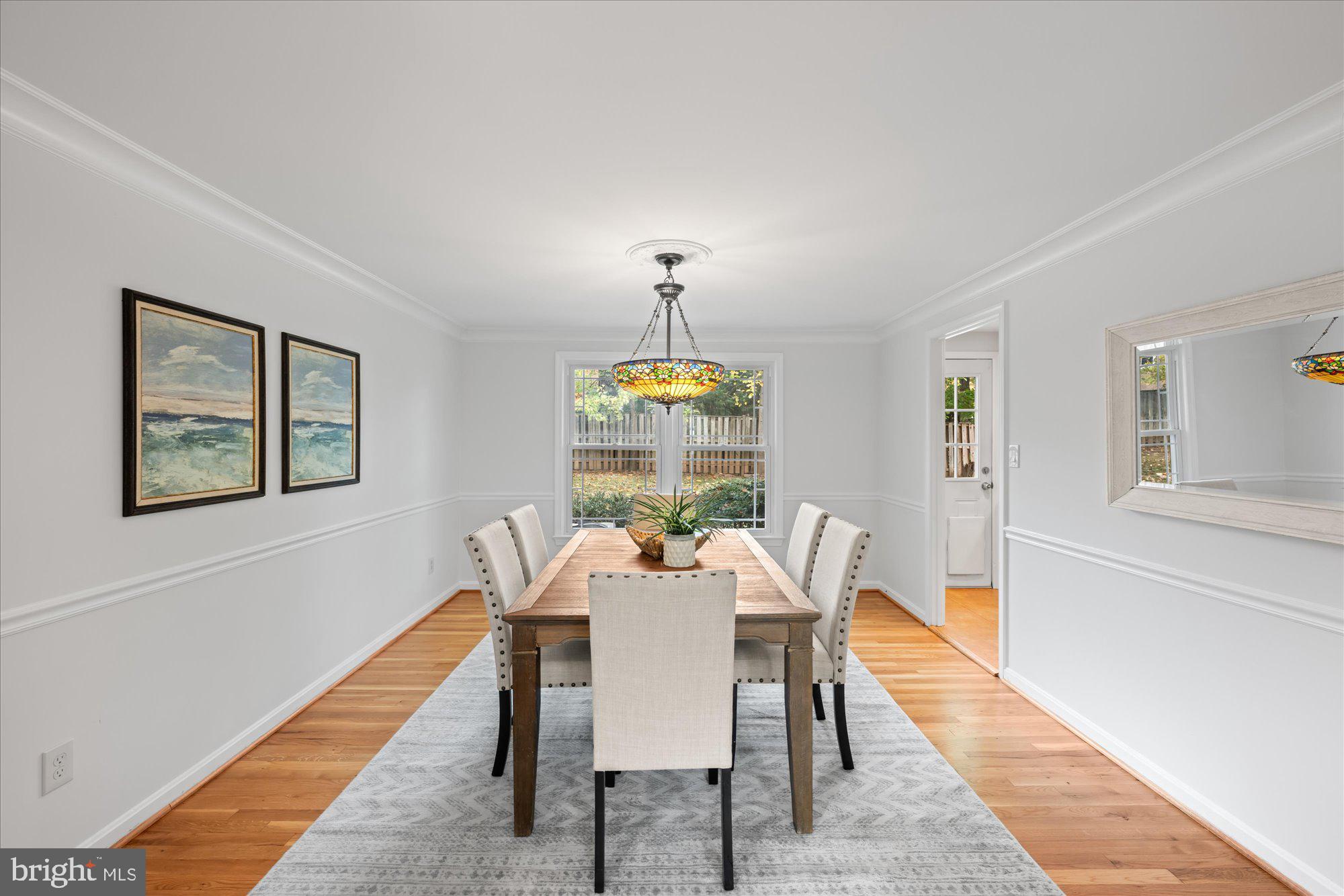8311 Aqueduct Road Potomac, MD 20854 - Photo 5 of 27 a view of a dining room with furniture window and wooden floor
