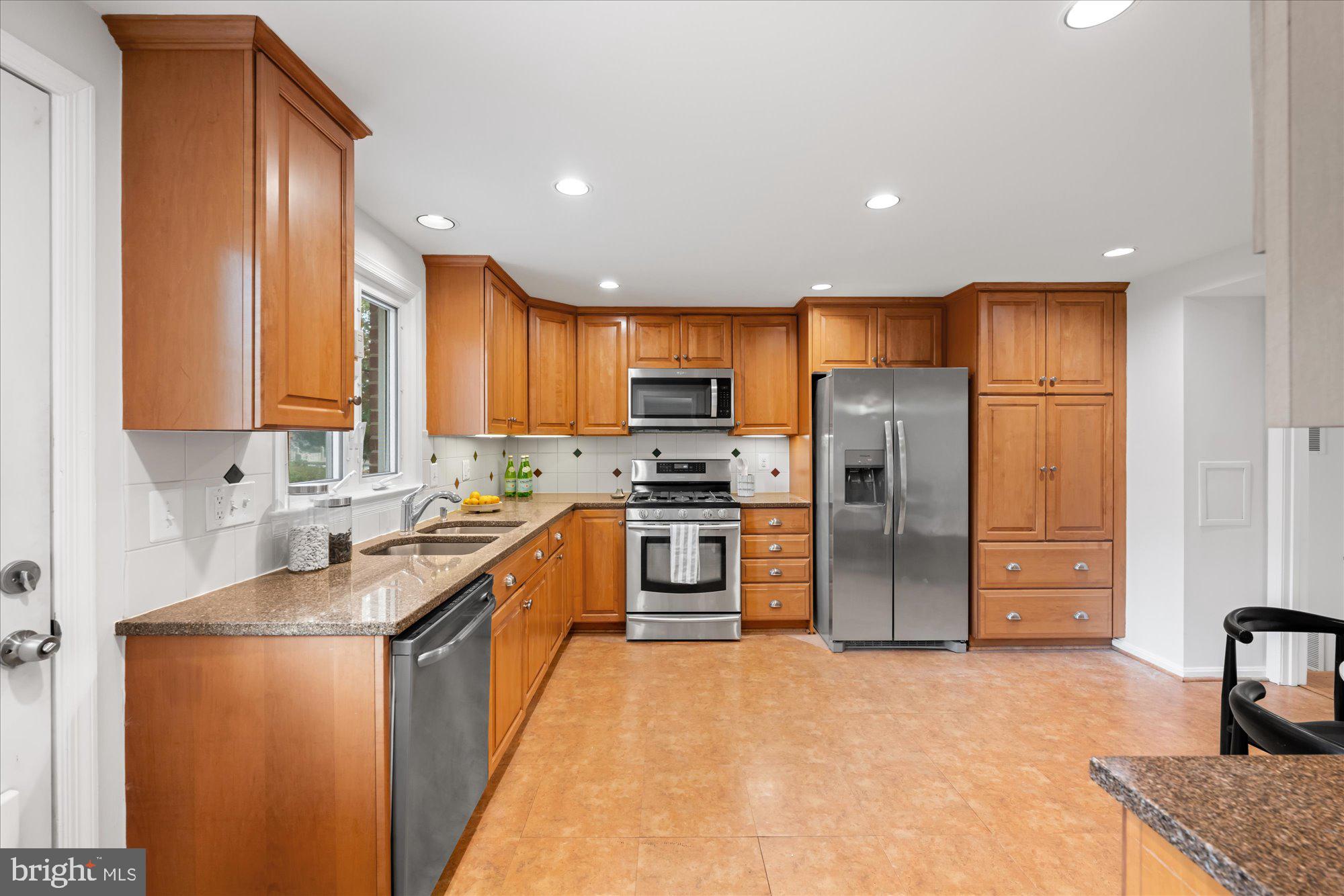 8311 Aqueduct Road Potomac, MD 20854 - Photo 8 of 27 a kitchen with stainless steel appliances granite countertop a refrigerator sink and stove