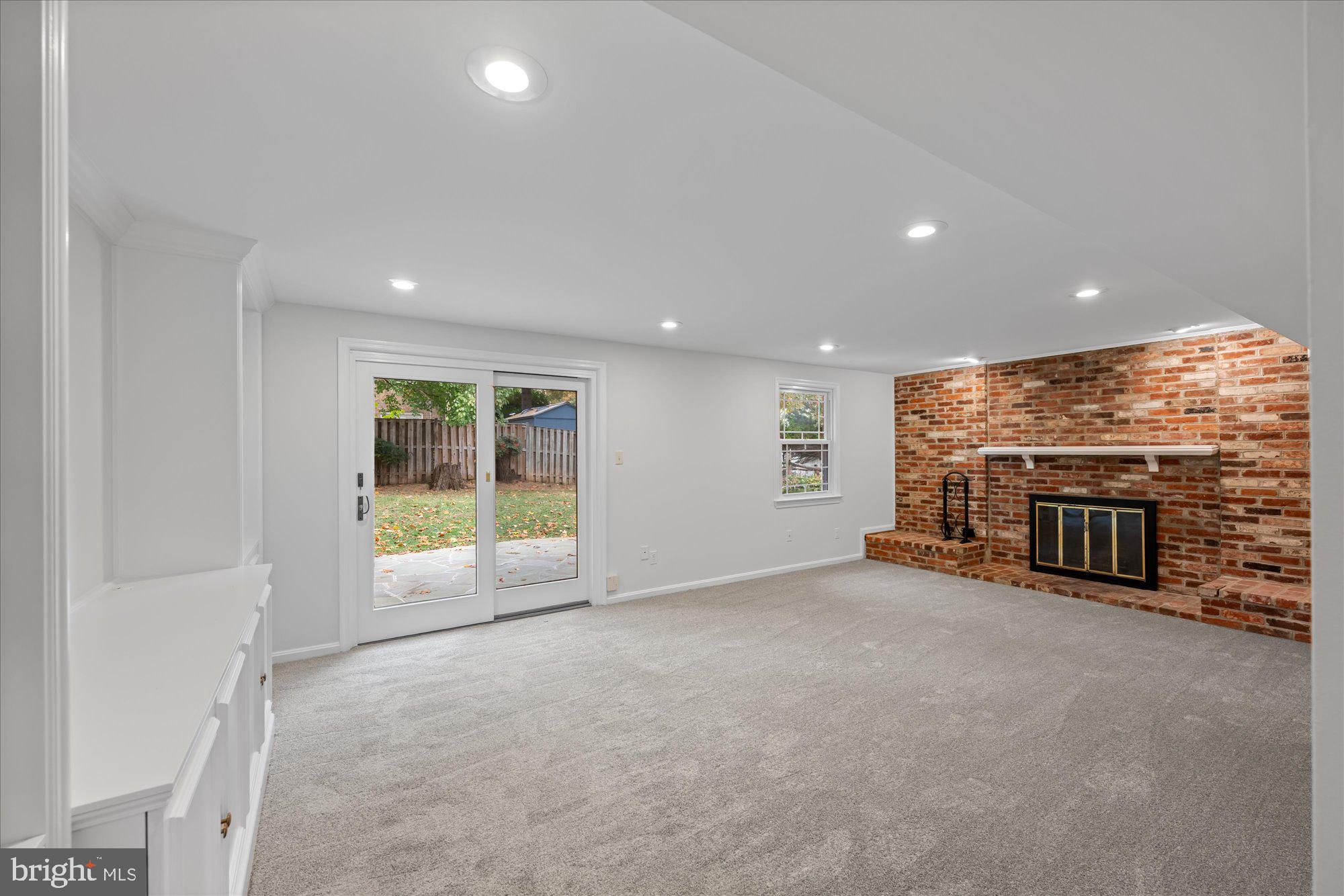 8311 Aqueduct Road Potomac, MD 20854 - Photo 9 of 27 an empty room with a fireplace and window