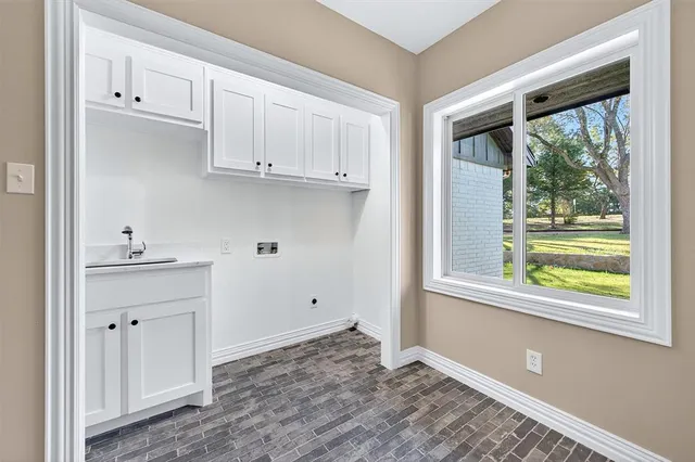 a view of kitchen with window and cabinets