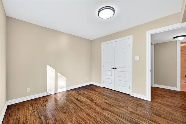 a bathroom with a granite countertop sink mirror vanity and toilet
