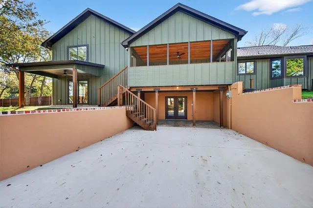 a view of a house with a patio and a yard